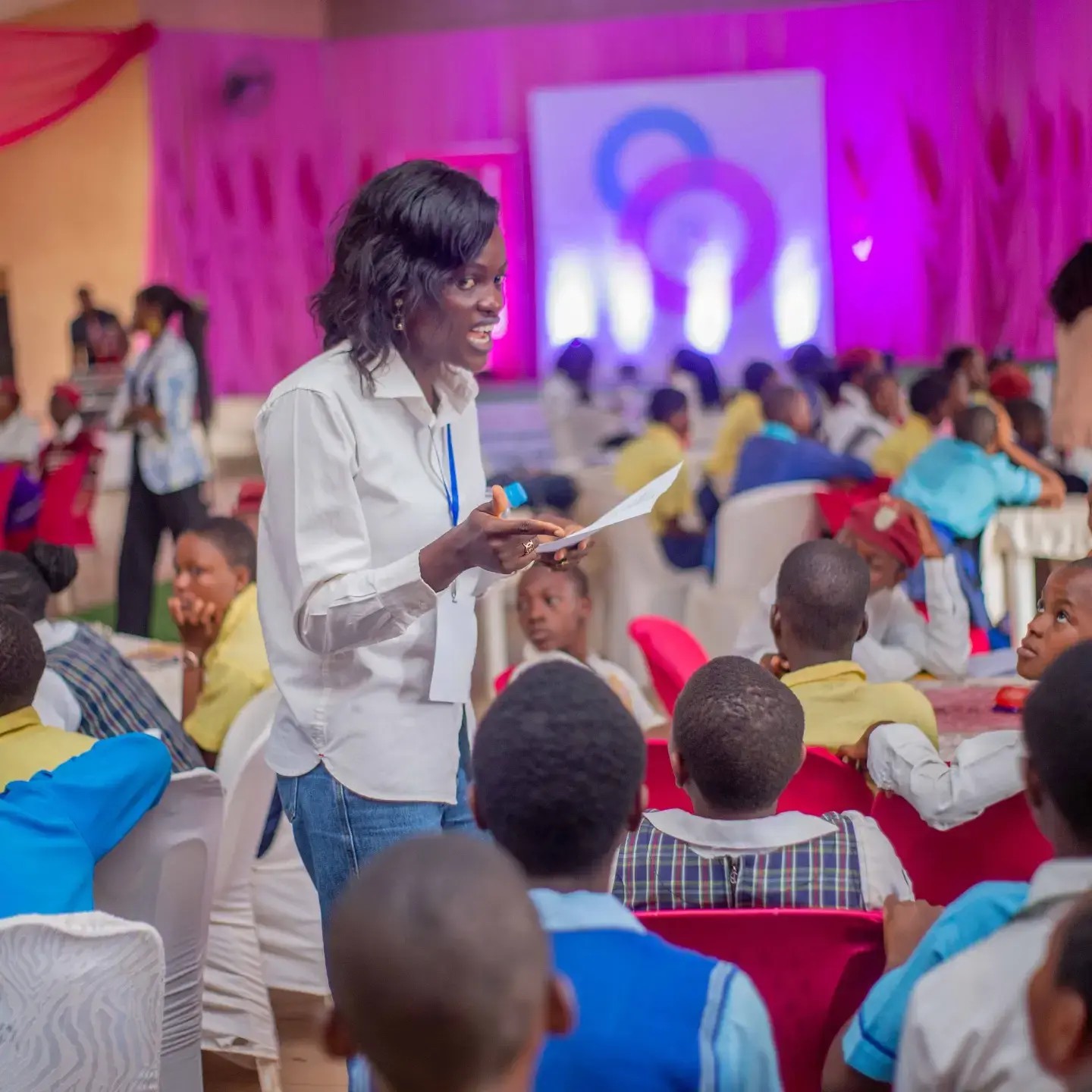 A mentor talking with girls seated in a small group